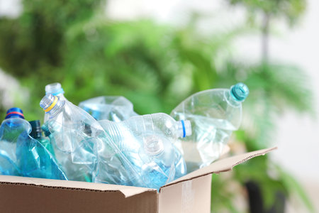 Cardboard box with used plastic bottles on blurred background. recycling problemの写真素材