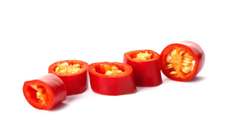 Slices of red chili pepper on white background