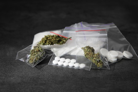 Cocaine, dried hemp and ecstasy on gray tableの写真素材