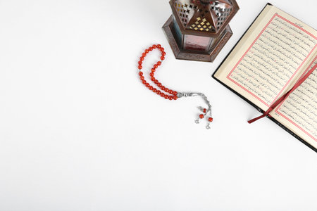 Muslim lamp, Koran and prayer beads on white background, top view with space for textの写真素材