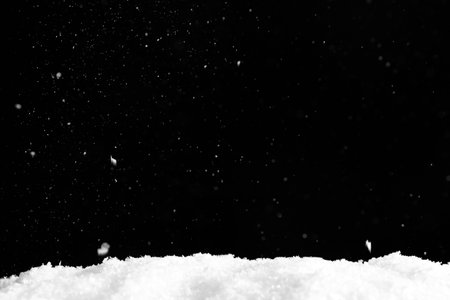 Snow flakes falling on black background. Winter weatherの写真素材