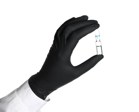 Doctor in medical glove holding ampoule on white backgroundの写真素材