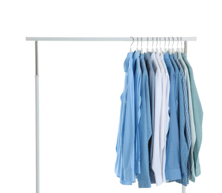 Men clothes hanging on wardrobe rack against white backgroundの写真素材