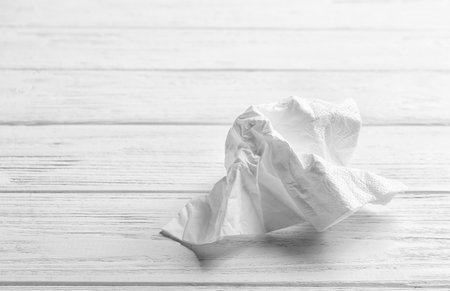 Crumpled napkin on wooden background, space for text. personal hygieneの写真素材