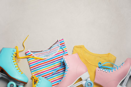 Flat lay composition with quad roller skates and space for text on light background