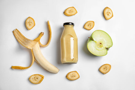 Flat lay composition with bottle of juice on white backgroundの写真素材