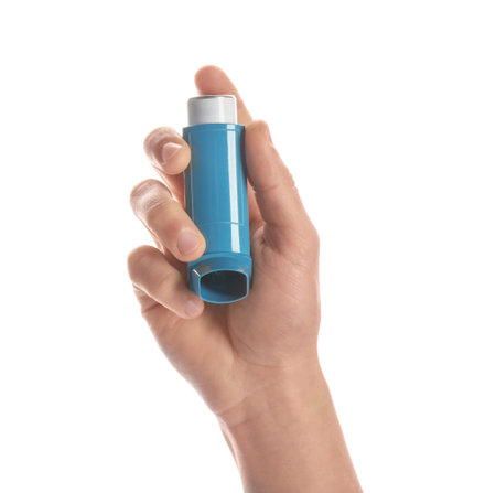 Man holding asthma inhaler on white background, closeup