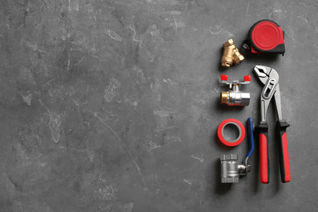 Flat lay composition with plumber's tools and space for text on gray backgroundの写真素材