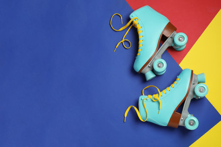 Pair of stylish quad roller skates on color background, top view with space for textの写真素材