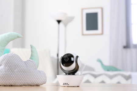 Baby monitor and toys on the table in the room. CCTV equipmentの写真素材