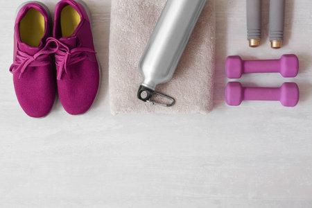 Flat lay composition with fitness equipment and space for text on gray background