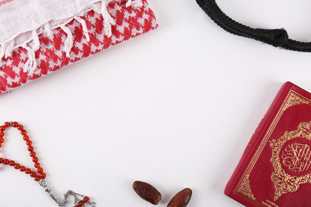 Flat lay composition with Muslim prayer beads, Quran and space for text on white backgroundの写真素材