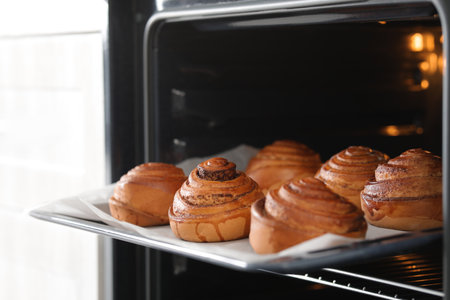 Open oven with tray of freshly baked buns, closeupの写真素材