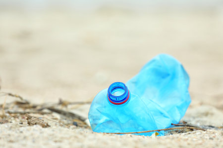 Used plastic bottle on beach, closeup with space for text. recycling problemの写真素材