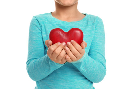 Boy holding decorative heart on white background, closeupの写真素材