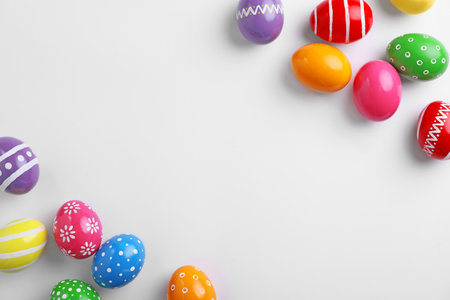 Decorated Easter eggs and space for text on white background, top viewの写真素材