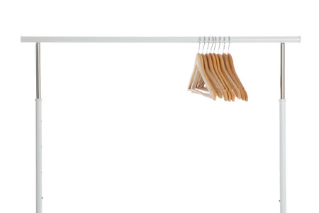 Wardrobe rack with wooden hangers isolated on whiteの写真素材