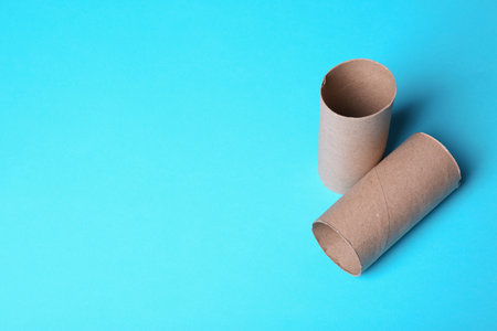 Empty toilet paper rolls and space for text on color backgroundの写真素材