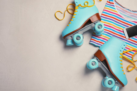 Flat lay composition with quad roller skates and space for text on light backgroundの写真素材
