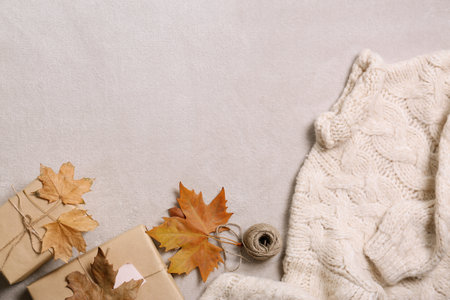 Flat lay composition with warm sweater and space for text on gray backgroundの写真素材