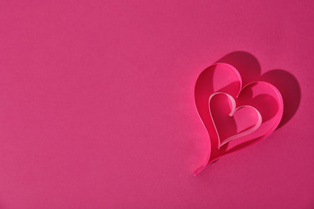 Hearts made of ribbons and space for text on color background, top viewの写真素材