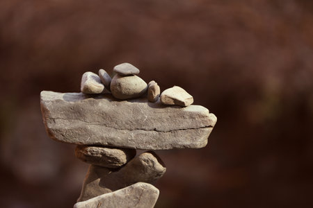 Tower of balancing stones against blurred background. Space for text