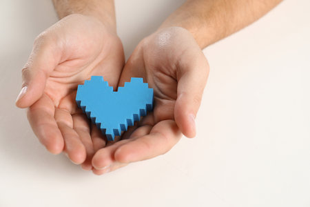 Man holding decorative heart on white background, closeupの写真素材