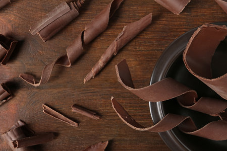Flat lay composition with chocolate curls on wooden backgroundの写真素材