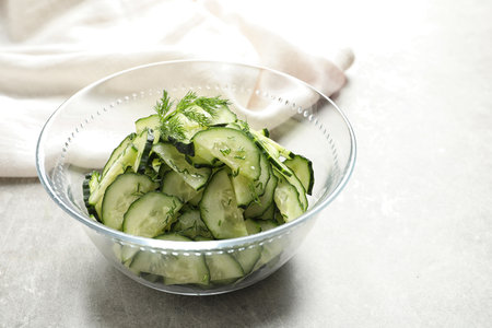 Delicious cucumber salad with dill in bowl on tableの写真素材