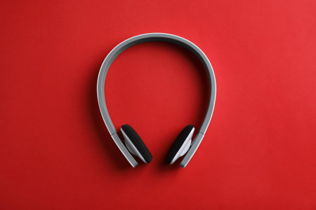 Wireless headphones on color background, top view