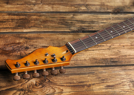 Modern electric guitar on wooden background. musical instruments