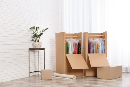 Wardrobe boxes with clothes near window indoorsの写真素材