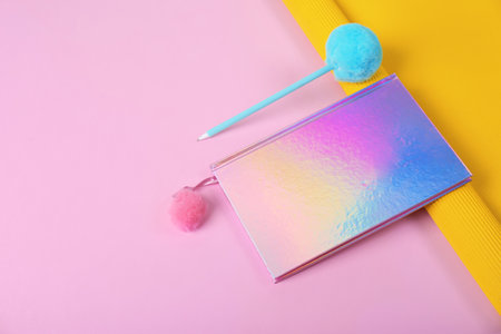 Beautiful notebook, pen and rolled paper on color background. Space for text