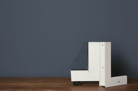 Sample of modern window profile on table against gray wall. Installation serviceの写真素材