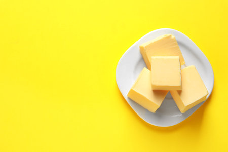Plate with fresh butter and space for text on color background, top viewの写真素材