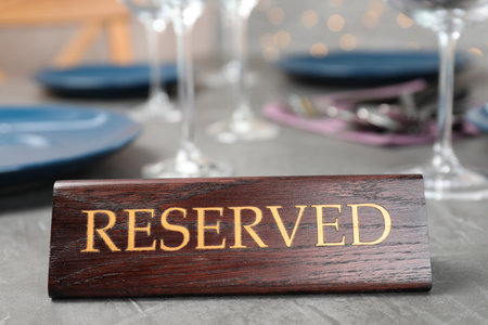 Table setting with RESERVED sign in restaurantの写真素材