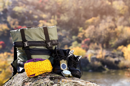 Set of camping equipment on rock outdoors. Space for textの写真素材