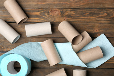 Flat lay composition with toilet paper and empty rolls on wooden backgroundの写真素材