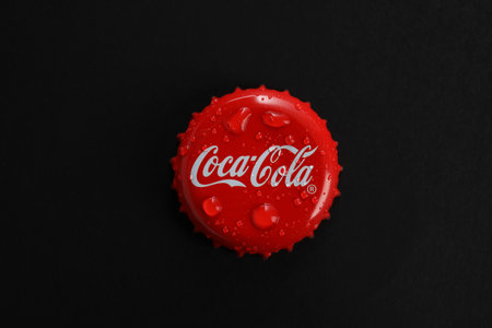 MYKOLAIV, UKRAINE - NOVEMBER 15, 2018: Coca Cola lid on black background, top viewのeditorial素材