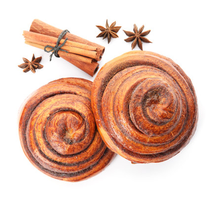 Freshly baked cinnamon rolls with ingredients on white background, top viewの写真素材