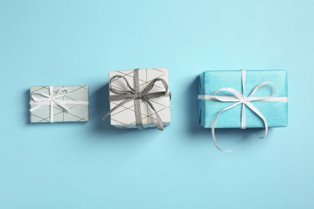Flat lay composition with beautiful gift boxes on color background