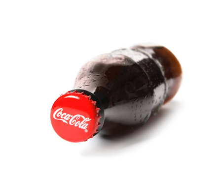 MYKOLAIV, UKRAINE - NOVEMBER 15, 2018: Glass bottle of Coca Cola on white background, focus on capのeditorial素材