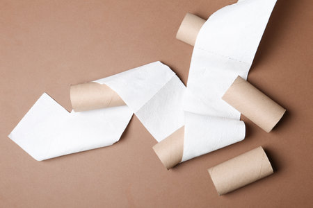 Flat lay composition with toilet paper and empty rolls on color backgroundの写真素材