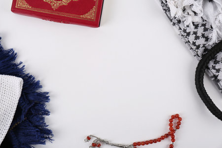 Flat lay composition with Muslim prayer beads, Quran and space for text on white backgroundの写真素材