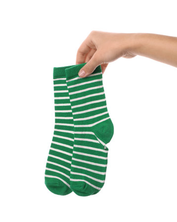 Woman holding pair of cute child socks on white background, closeupの写真素材