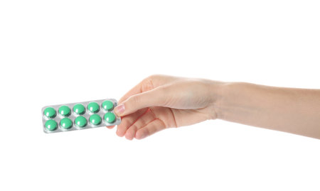Woman holding pills in blister pack on white background, closeupの写真素材