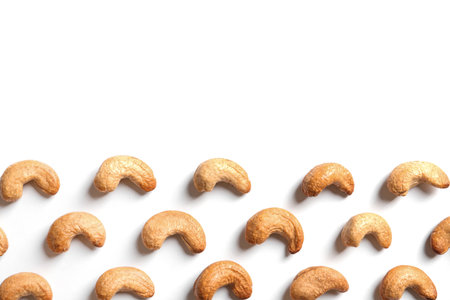 Tasty roasted cashew nuts on white background, top view. Space for textの写真素材