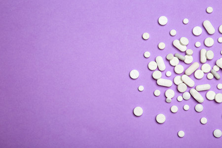 Flat lay composition with pills and space for text on color background. medical treatmentの写真素材