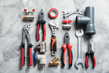 Flat lay composition with plumber's tools on gray backgroundの写真素材