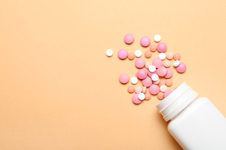 Flat lay composition with pills and space for text on color background. medical treatmentの写真素材